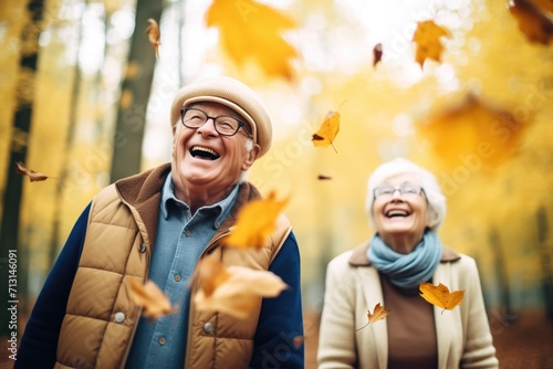 retired couple playfully throwing autumn leaves in a forest