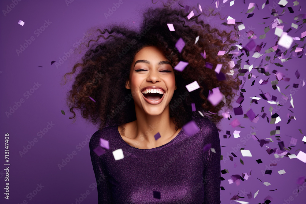 Energetic active African American lady dancing moving on holiday with flying confetti isolated on violet color background Energetic active African American lady dancing moving on holiday with flying confetti isolated on violet color background
