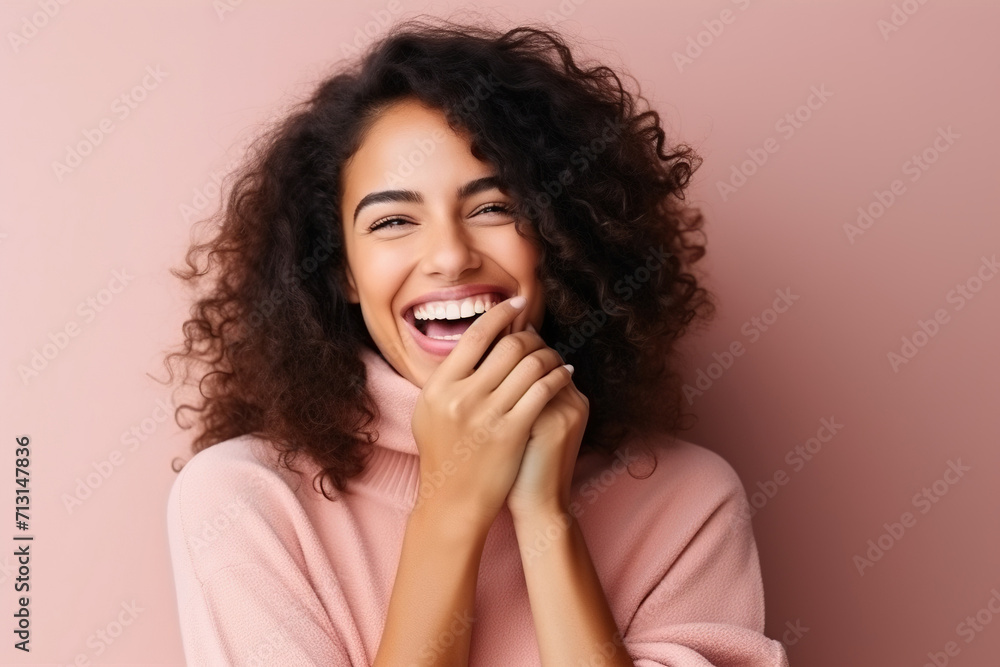 Positive beautiful woman with hands covering mouth laughing cheerfully against background Positive beautiful woman with hands covering mouth laughing cheerfully against background