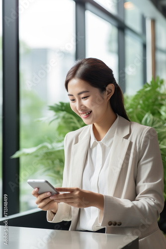 Free Download Young busy happy Asian business woman manager using mobile cell phone tech in office - GFXLoad