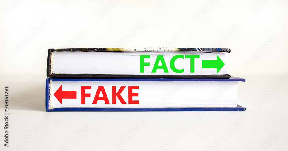 Fact or fake symbol. Concept word Fake and Fact on beautiful books. Beautiful white table white background. Business and fact or fake concept. Copy space.