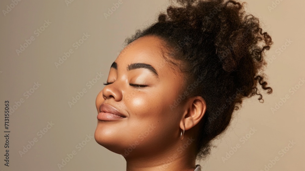 A radiant smile lights up the studio in a portrait of a joyful plus-size woman. A radiant smile lights up the studio in a portrait of a joyful plus-size woman.