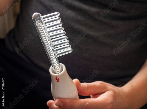 Close up shot of the high frequency comb tool for hair and scalp treatment. Healthcare