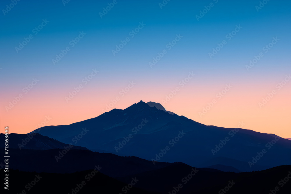 Dusk Silhouette of a Lone Mountain Peak
