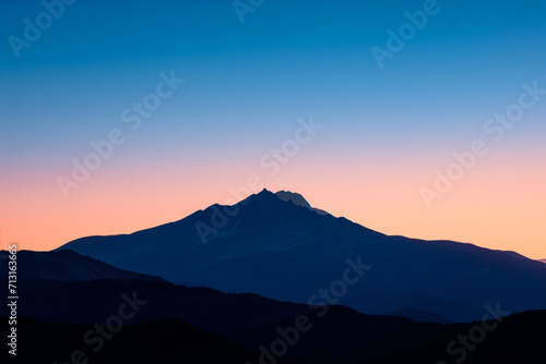 Dusk Silhouette of a Lone Mountain Peak