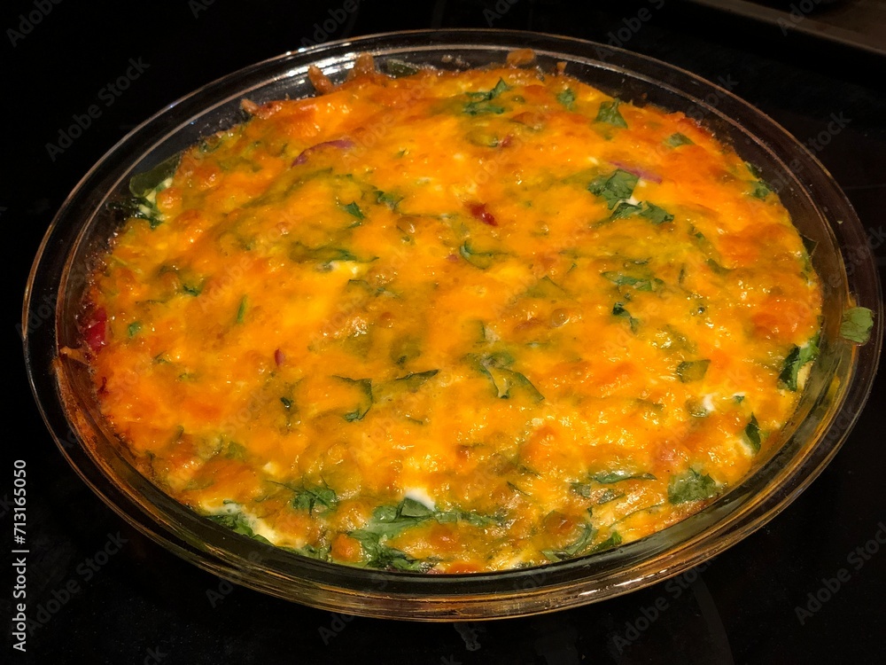 Spinach omelet in a glass bowl on a black background Spinach omelet in a glass bowl on a black background