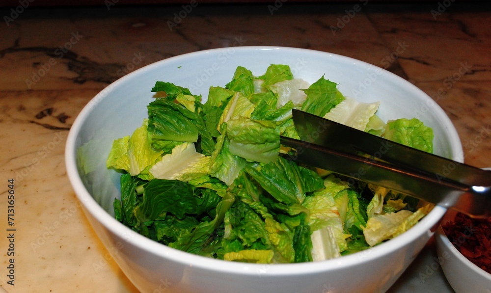 Salad in a bowl with knife and fork on the table. Salad in a bowl with knife and fork on the table.