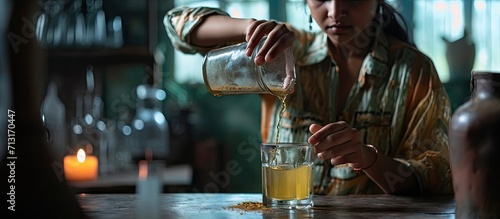 Close up young indian woman pouring soluble anti influenza powder in glass of water Sick millennial girl student feeling unwell relieving grippe fever flu symptoms high temperature headache photo