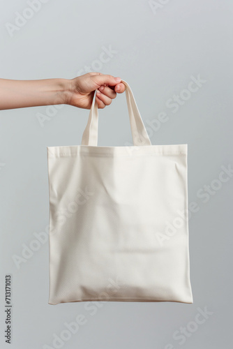 Hand holding blank tote bag