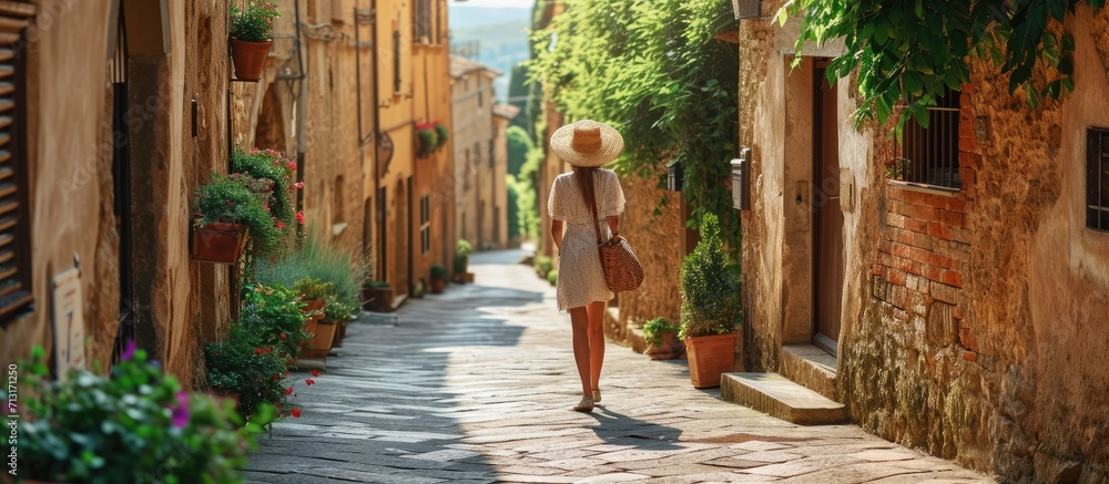 Fototapeta premium Travel in Italy happy trendy woman with straw bag having excursion in Pienza in Tuscany Italy. Copy space image. Place for adding text