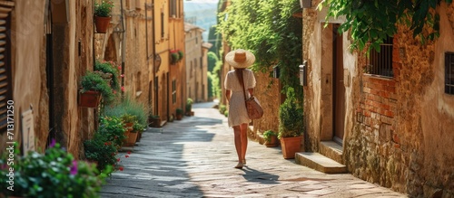 Travel in Italy happy trendy woman with straw bag having excursion in Pienza in Tuscany Italy. Copy space image. Place for adding text
