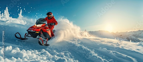 Snowmobile Jump Extreme Snowmobile Ride Racing a bright suit and a snow motorcycle Winter Recreation high resolution and photo quality. Copy space image. Place for adding text