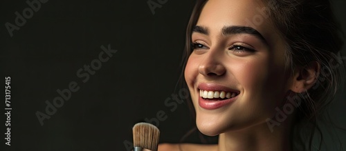 Brown haired woman baring her teeth and holding a paintbrush. Copy space image. Place for adding text photo