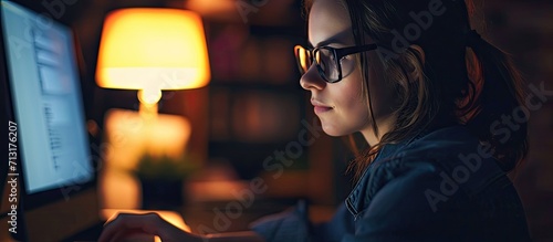 Woman reading and glasses reflection in office at night working on computer email or planning business schedule Female worker pc tech screen and overtime web research in dark company workplace photo