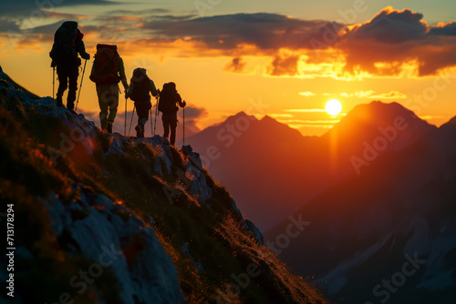 Hikers Silhouetted Against Mountain Sunset
