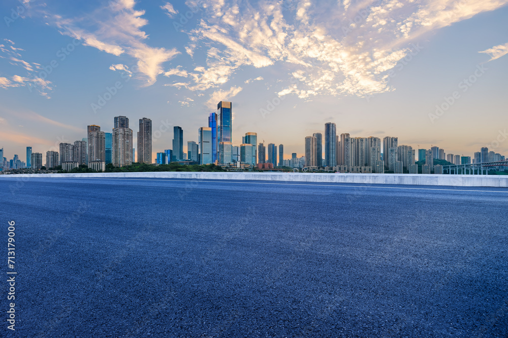 Empty asphalt road and city buildings skyline Empty asphalt road and city buildings skyline