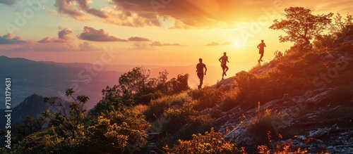 Fitness exercise and couple running in nature by a mountain training for a race marathon or competition Sports health and athletes or runners doing an outdoor cardio workout together at sunset