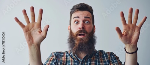 Young man with beard working at pain recovery clinic disgusted expression displeased and fearful doing disgust face because aversion reaction with hands raised. Copy space image