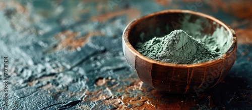 Green bentonite clay powder in a bowl Clay texture close up Diy mask and body wrap recipe Natural beauty treatment and spa. Copy space image. Place for adding text photo