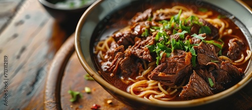 Photo of freshly cooked Filipino food called Beef Pares Mami or tender cubed beef briskets paired with noodles. Copy space image. Place for adding text photo