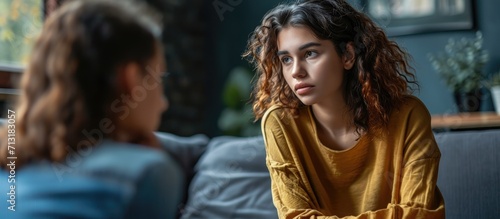 Young woman victim of domestic violence or robbery or mobbing at work talks to an expert psychotherapist for therapy in a comfortable apartment Psychologist discuss mental problems trauma after photo