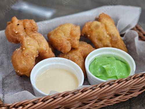 Deep-fried dough stick serving with green kaya dipping in woven basket