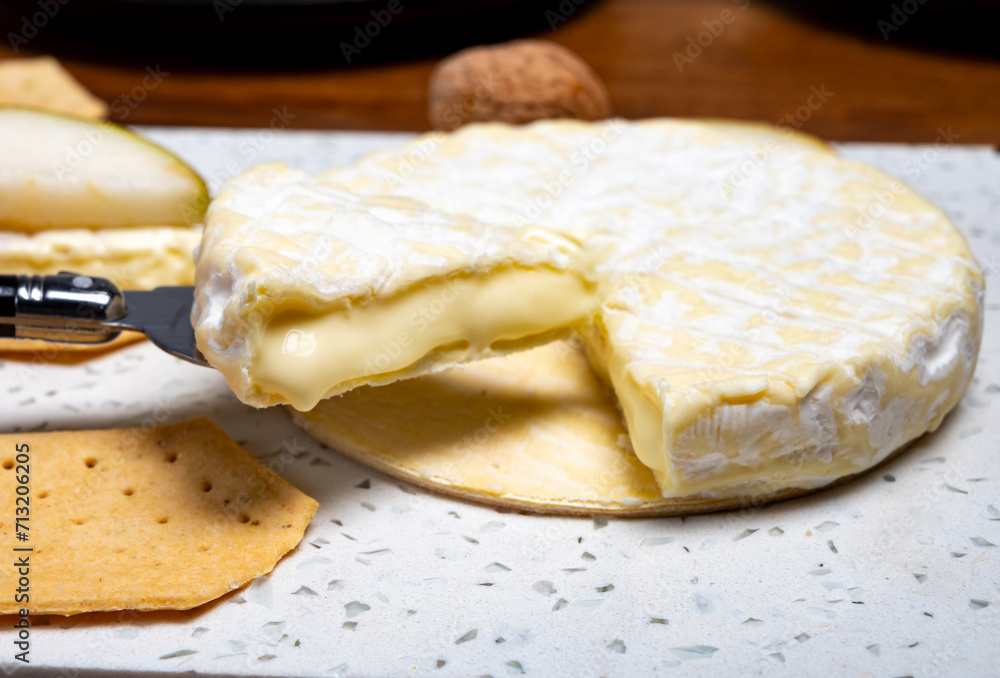 French soft Cremeux de Normandie cheese, soft creamy cheese with white mold French soft Cremeux de Normandie cheese, soft creamy cheese with white mold