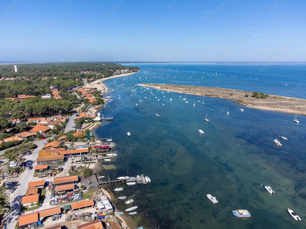 View on Arcachon Bay with many fisherman's boats and oysters farms near Le Phare du Cap Ferret and Duna du Pilat, Cap Ferret peninsula, France, southwest of Bordeaux, France's Atlantic coastline
