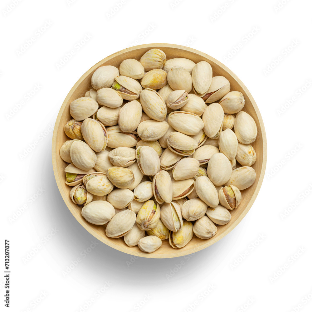 Wooden bowl with delicious and tasty ready-to-eat pistachios, nuts in shell, with transparent bottom and shade