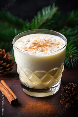 Cup of Eggnog or egg milk punch Christmas traditional drink with spices on wood table