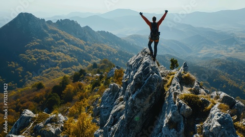Happy man with arms up jumping on the top of the beautiful mountain - Successful hiker celebrating success on the cliff