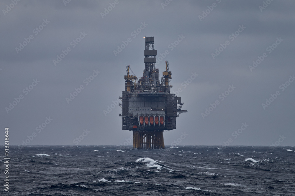 Picture of offshore oil and gas drilling rig in the sea in stormy weather.