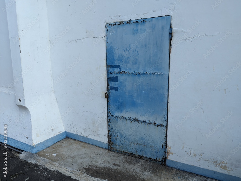 Rusty blue iron door commonly used in old textile factories