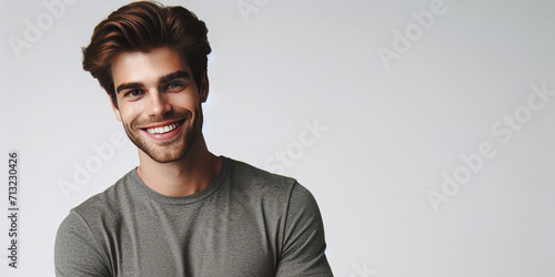 studio photograph of a happy young man posing at white studio background © AI_ID