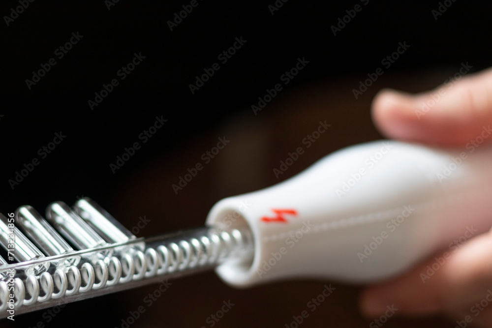 Close up shot of the high frequency comb tool for hair and scalp treatment. Healthcare Close up shot of the high frequency comb tool for hair and scalp treatment. Healthcare