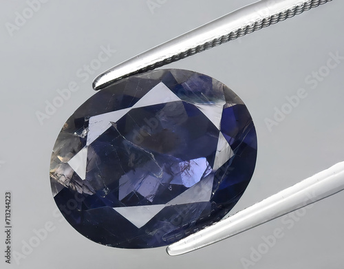natural blue iolite kordierite gem on the background photo