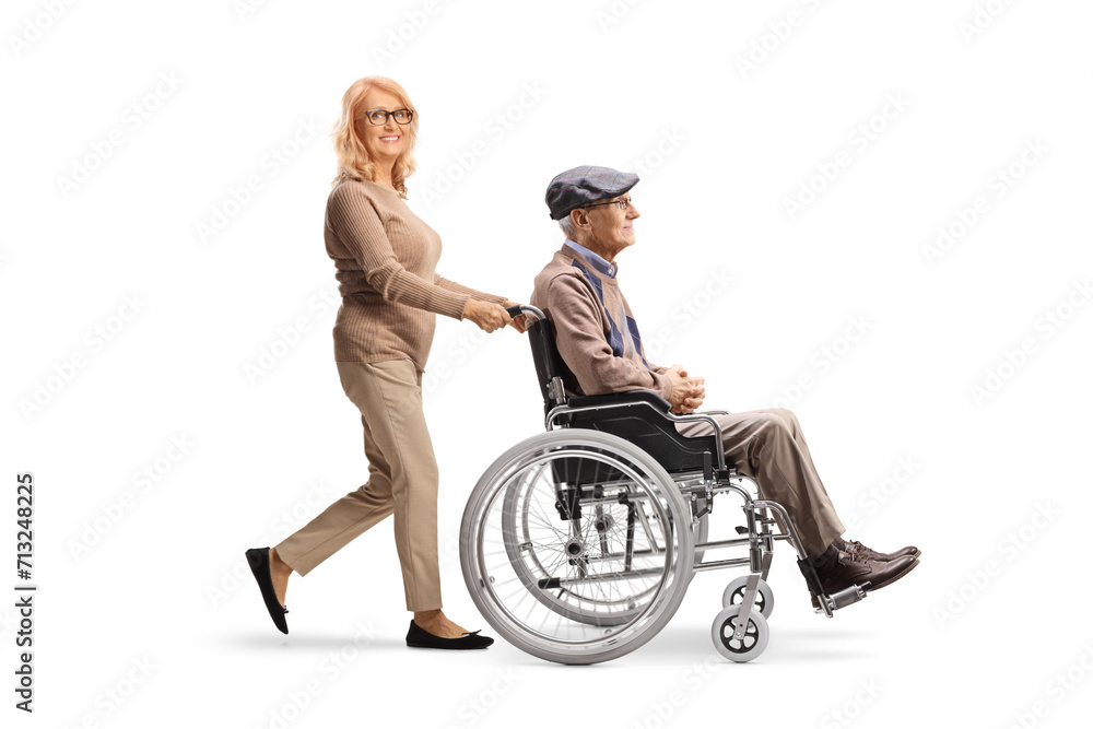 Woman pushing a senior man in a wheelchair Woman pushing a senior man in a wheelchair