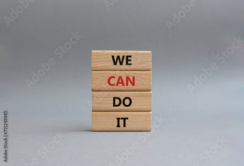 We can do it symbol. Concept words We can do it on wooden blocks. Beautiful grey background. Business and We can do it concept. Copy space.