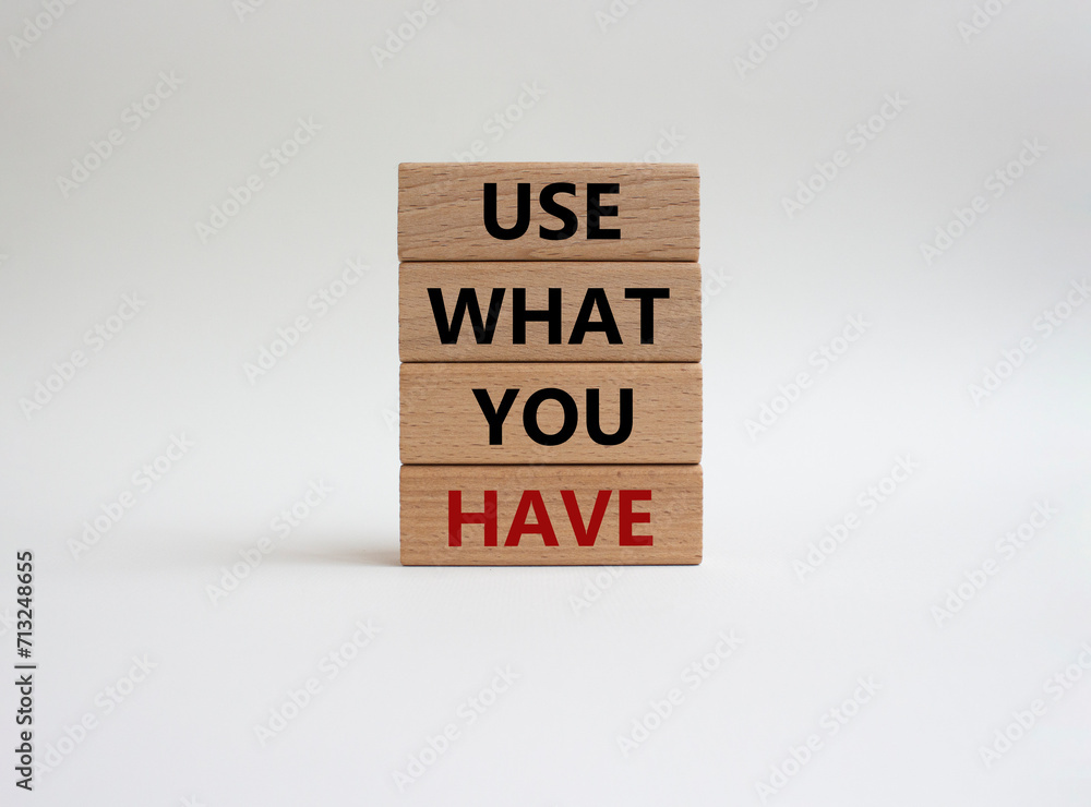 Naklejka premium Use what you Have symbol. Concept words Use what you Have on wooden blocks. Beautiful white background. Business and Use what you Have concept. Copy space.