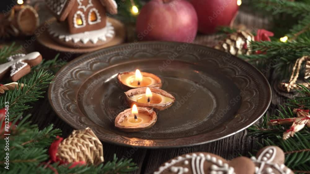 Christmas candles made of walnut shells and beeswax floating in water Christmas candles made of walnut shells and beeswax floating in water