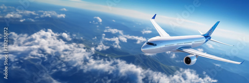 Airplane is flying over mountains and beautiful clouds. Landscape with passenger airplane, hills in low clouds, blue sky. aircraft. Business travel. Commercial plane. Aerial view