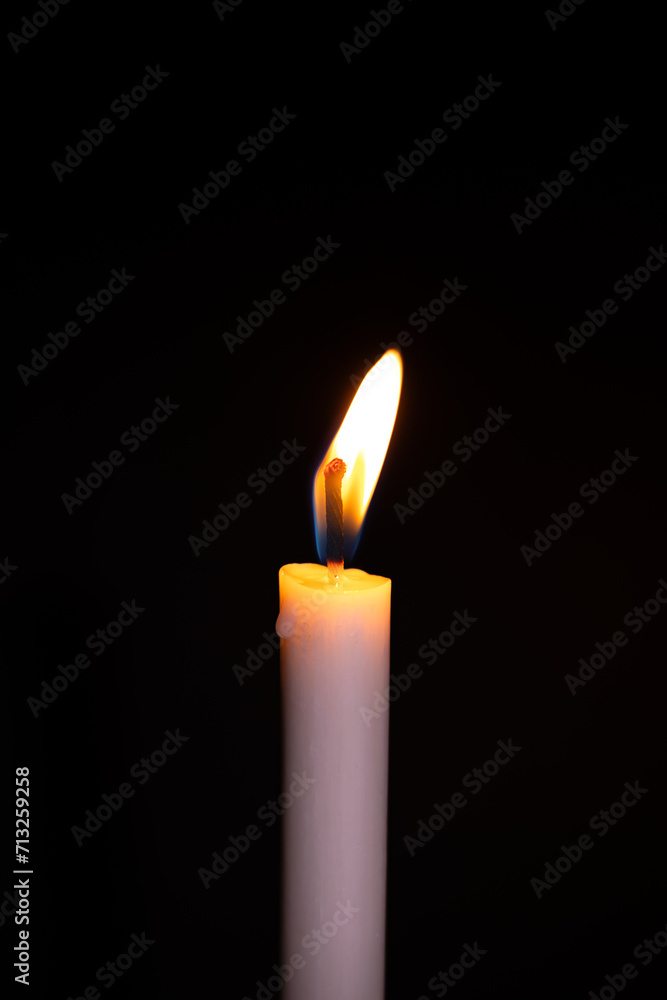 Burning White Candle on the dark, flame of candle on black background Burning White Candle on the dark, flame of candle on black background