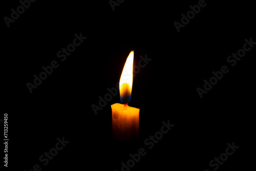 Burning White Candle on the dark, flame of candle on black background