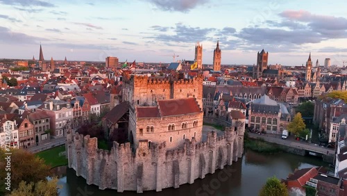 Aerial view of famous places Castle of the Counts next to river Lys. Beautiful architecture and landmarks of the medieval city on a sunset. Ghent, Belgium photo