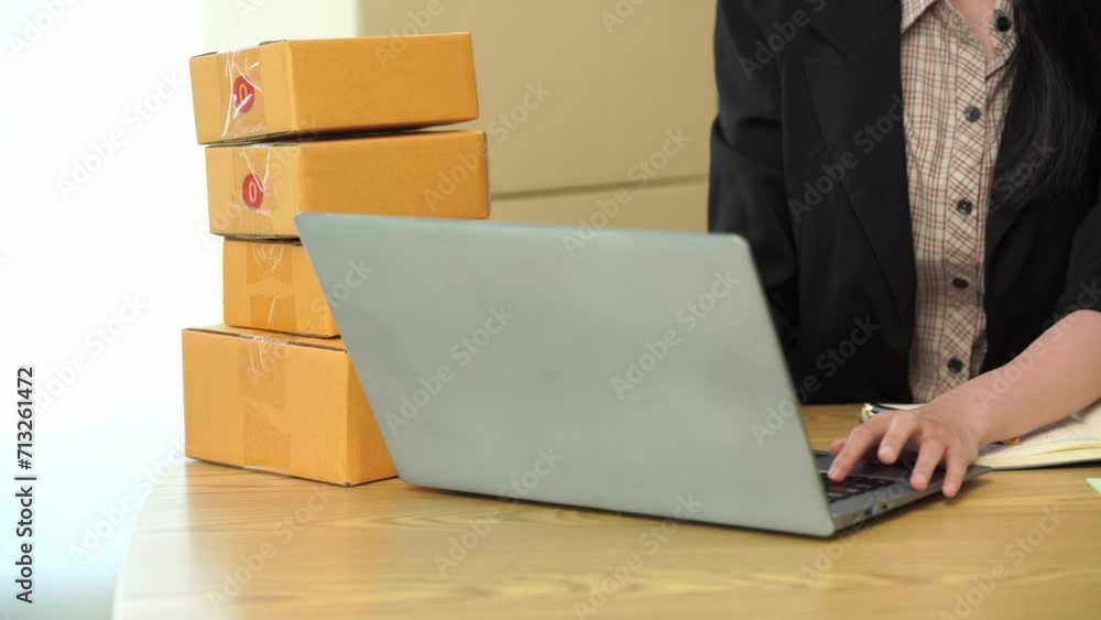 Starting a small business. Asian woman SME owner checks online orders. Selling products that work with boxes, freelancing at home, online sme business, small medium enterprises, 4k video Starting a small business. Asian woman SME owner checks online orders. Selling products that work with boxes, freelancing at home, online sme business, small medium enterprises, 4k video