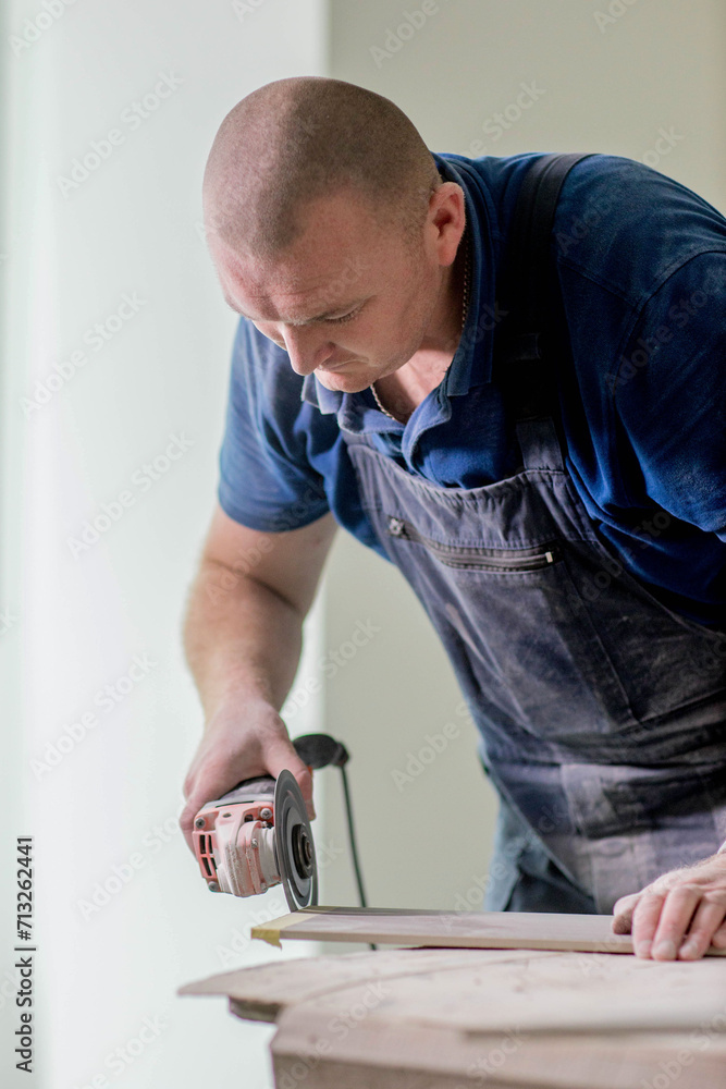 Professional tiler cutting ceramic tile for the floor or wall. Flooring and tiling. Professional tiler cutting ceramic tile for the floor or wall. Flooring and tiling.