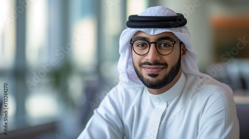 Happy Arab man in office dressed in kandura © cherezoff
