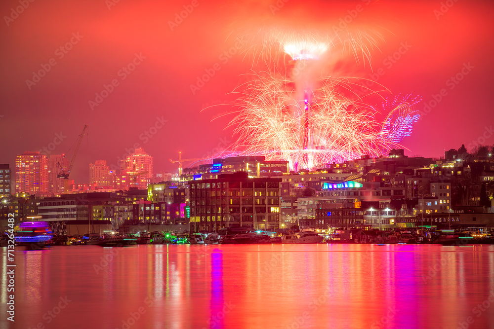 Scenic view of vibrant fireworks illuminate the night sky of Seattle
