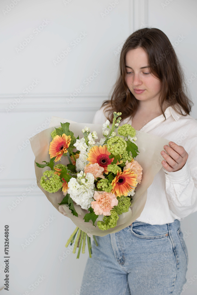 Bouquet for the bride in female hands. Flowers for the wedding. Leukadendron, ranunculus, genista. Tulips, roses, carnation shabot. Gift on the 8 march. Plans for valentines day.