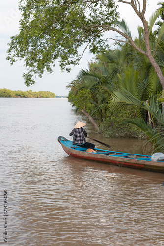 Boat tour in the Mekong River Delta region with coconut palm trees - Ben Tre, South Vietnam © muratart